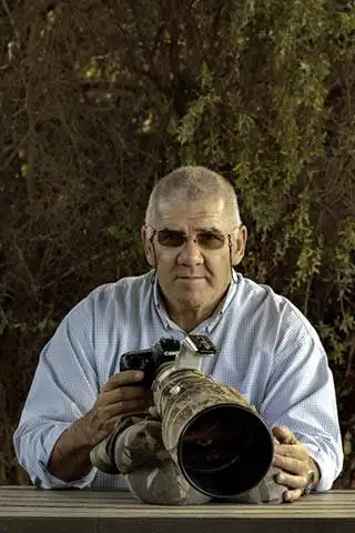 About Me 1 About Me Tony Sparkes holding a camera and sat down.