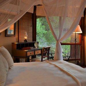 Hamiltons Tented Camp - Bed and desk in a bedroom
