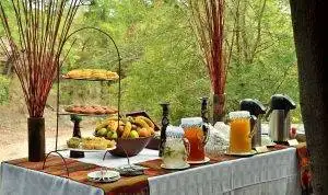 Imbali-Safari-Lodge-Breakfast table with fruit and juice