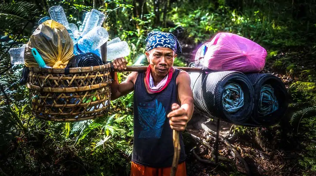 What is Eco Tourism - Man Collecting Plastic Bottles - Safari Buddies Blog