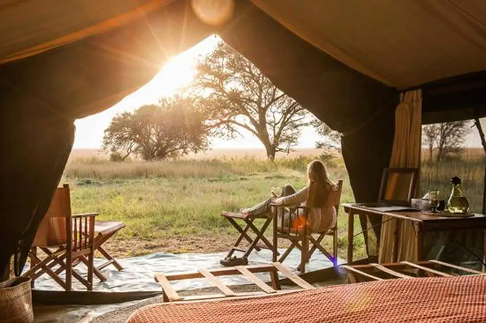 Safari in Tanzania 16 Tented Camp Deck with women in chair