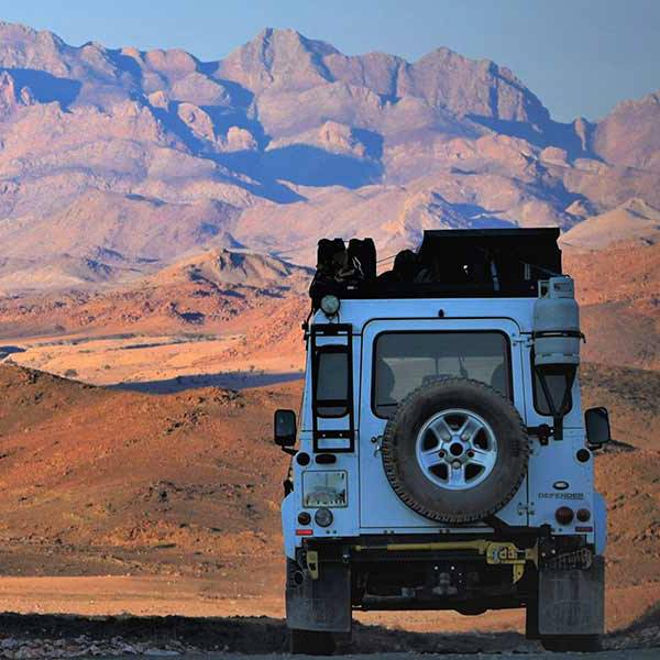 Land Rover driving towards mountains