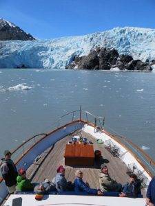 Glacier look from a boat with people on deck