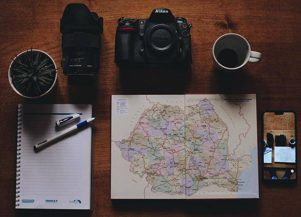 Wildlife Planning - camera, Map and coffee mug on a table