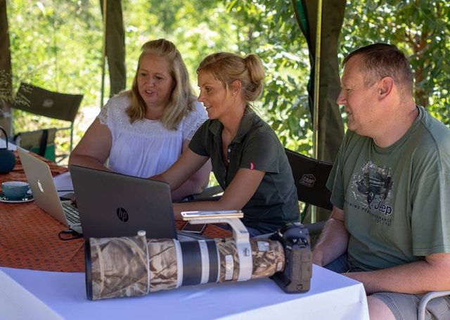 Post Editing in the Bush with 3 people at a computer